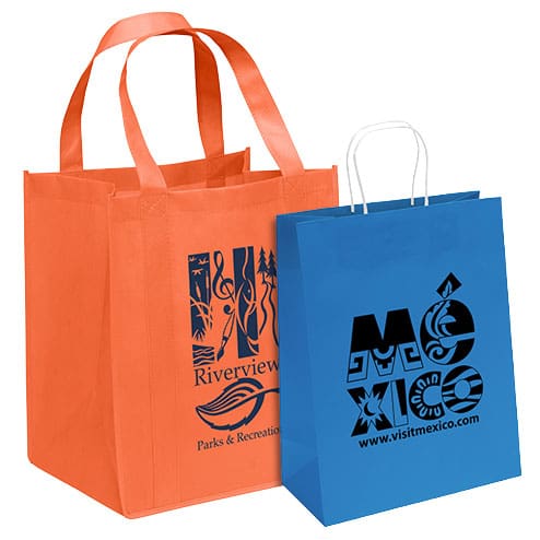 Custom imprinted reusable grocery bag and paper shopping bag featuring sample logos for churches, businesses, schools and promotional events.