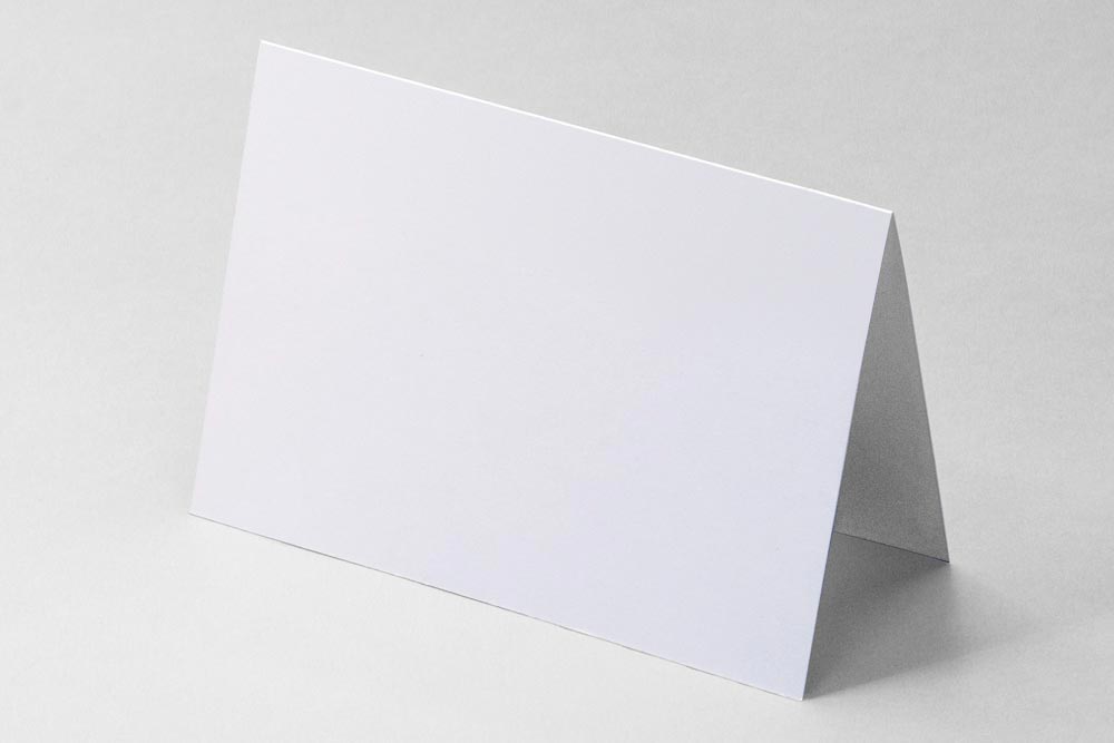 White cardstock folded into a tent shape to demonstrate how paper bends along a fold.